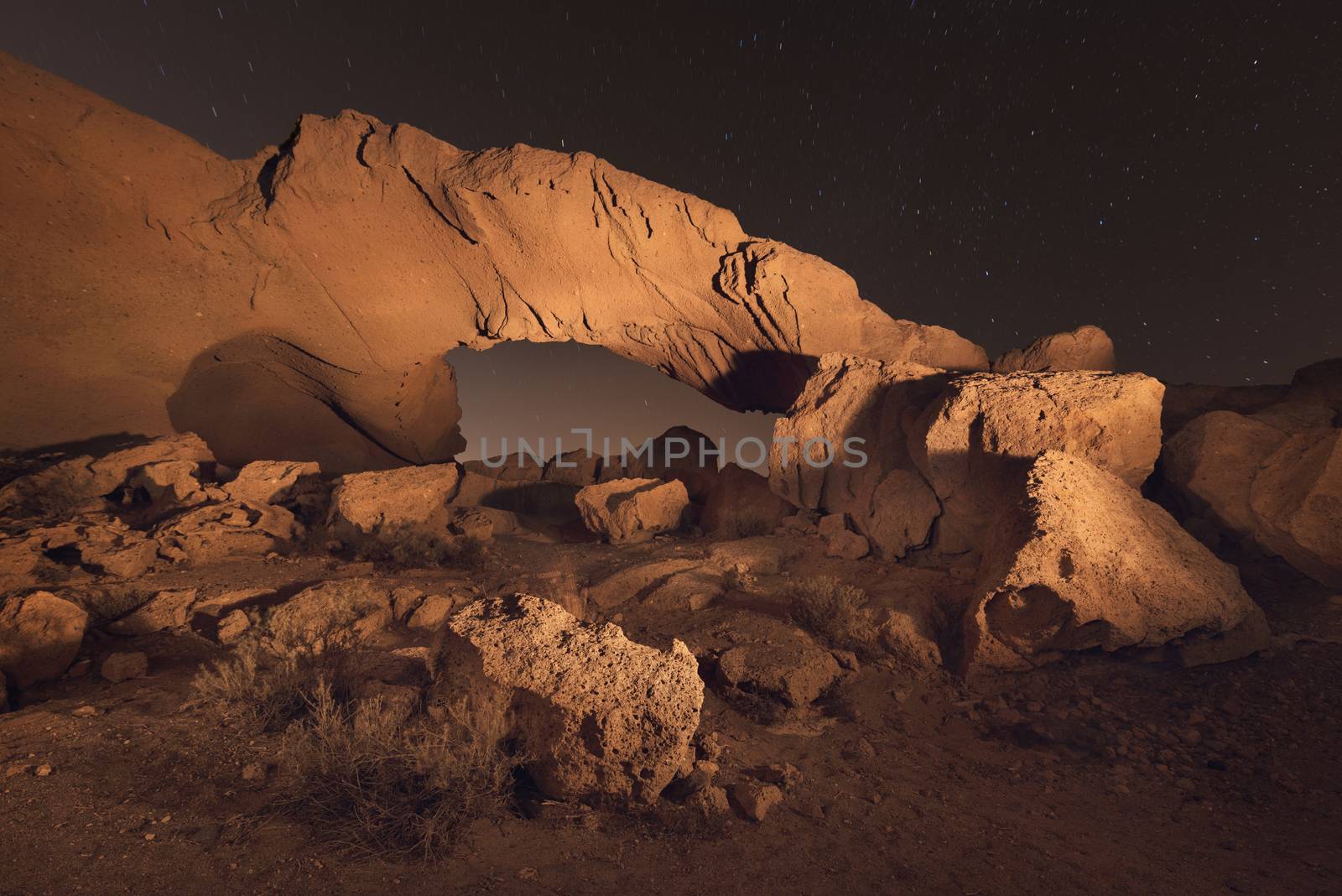 Starry night landscape of a volcanic Rock arch in Tenerife, Canary island, Spain. by HERRAEZ