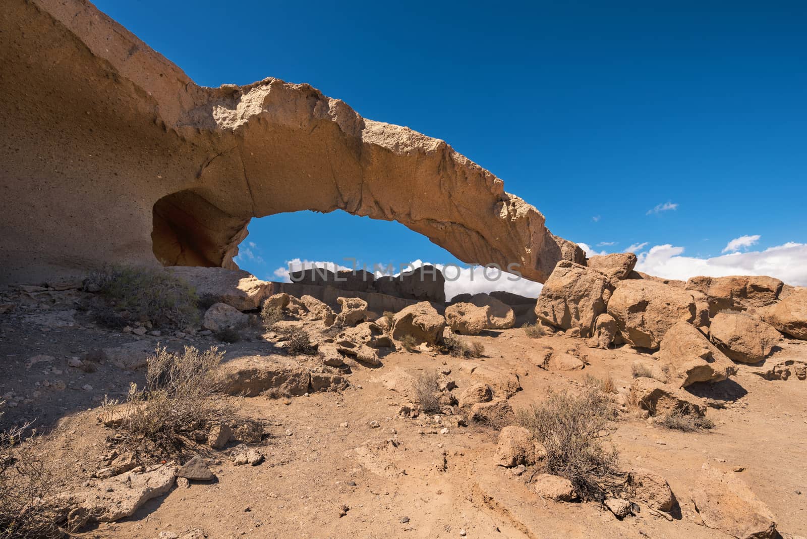 Natural volcanic rock arch formation in desertic landscape in Tenerife, Canary islands, Spain.