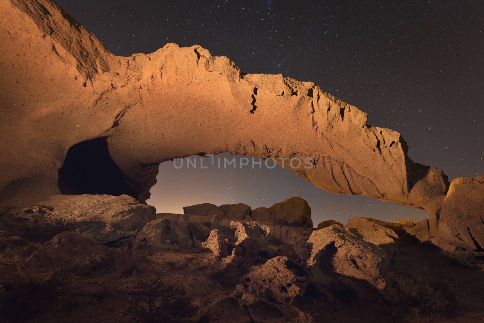 Starry night landscape of a volcanic Rock arch in Tenerife, Canary island, Spain.