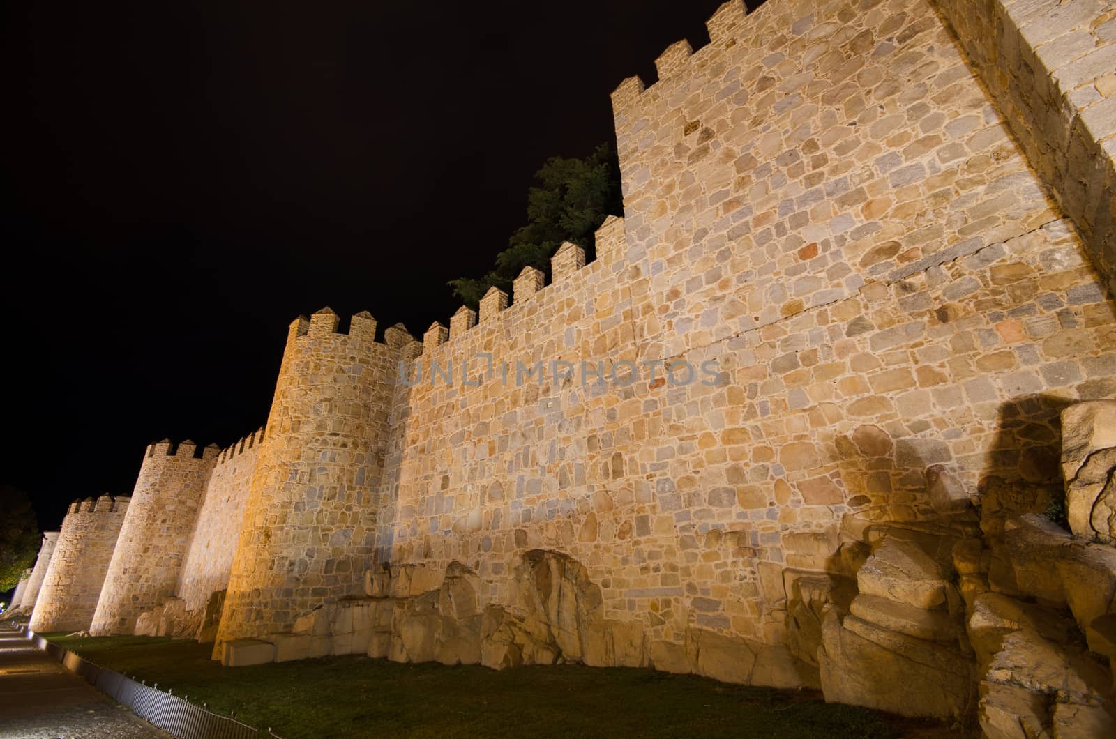 Night scene of famous Avila city walls in Castilla y Leon, Spain by HERRAEZ