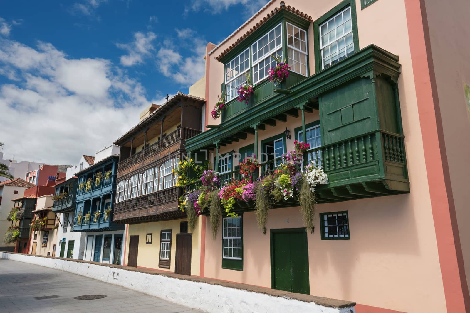 Famous ancient colorful colonies balconies decorated with flowers. Colonial houses facades in Santa Cruz, La Palma island in Spain
