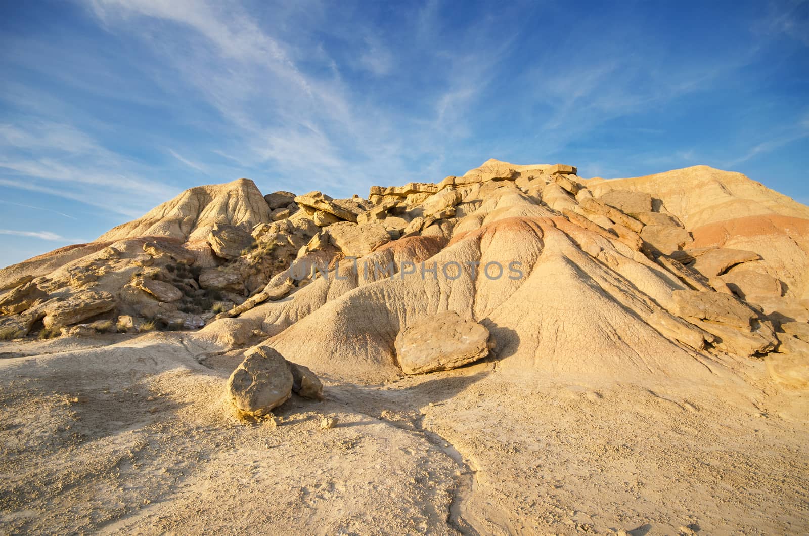 Scenic view of a desertic landscape at sunset in Bardenas Reales, Navarra, Spain. by HERRAEZ