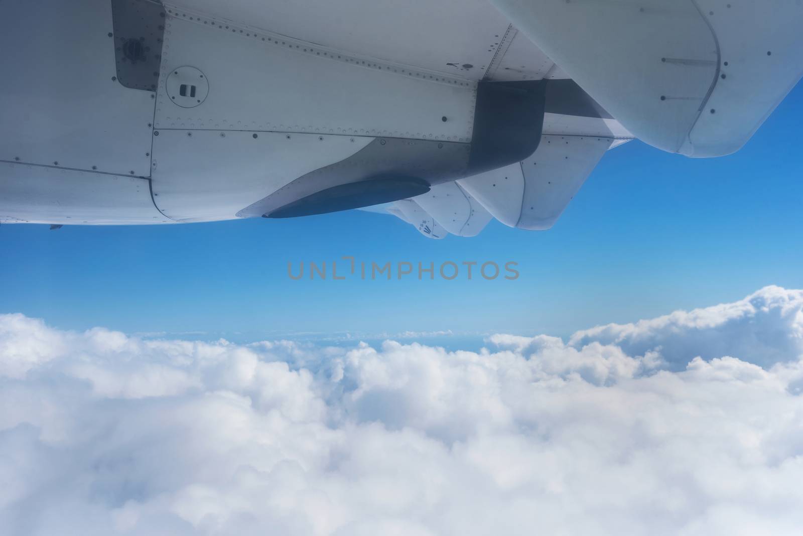 View of the clouds and the ocean from the airplane window. by HERRAEZ