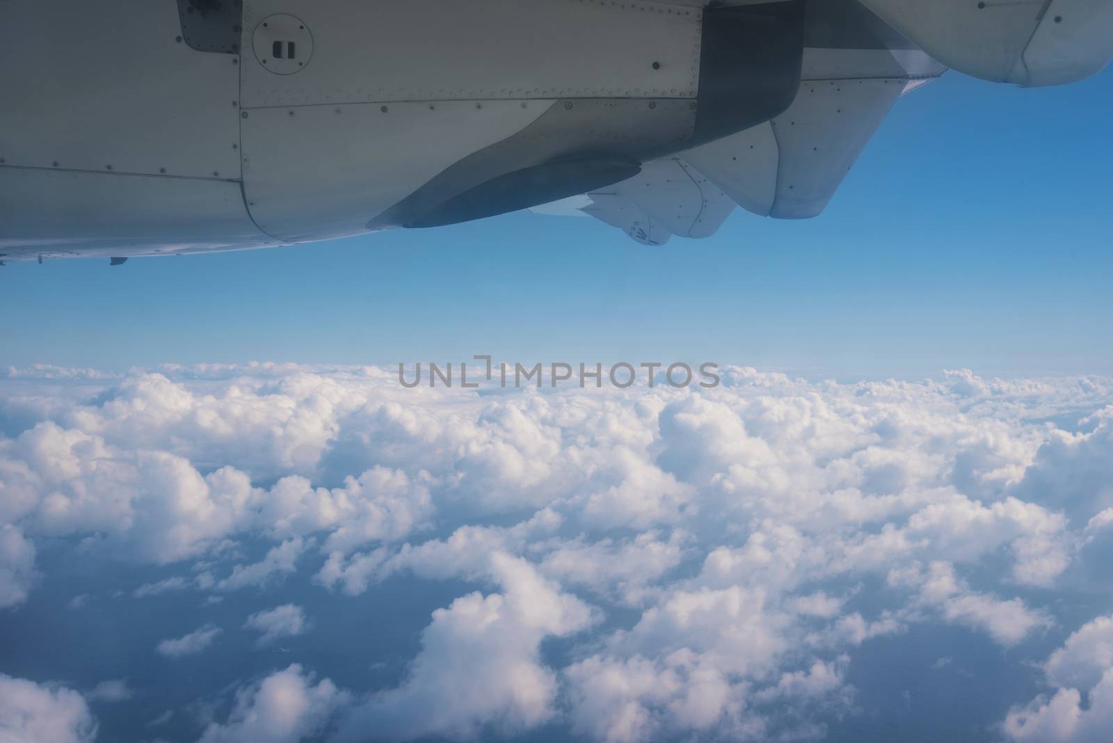 View of the clouds and the ocean from the airplane window. by HERRAEZ