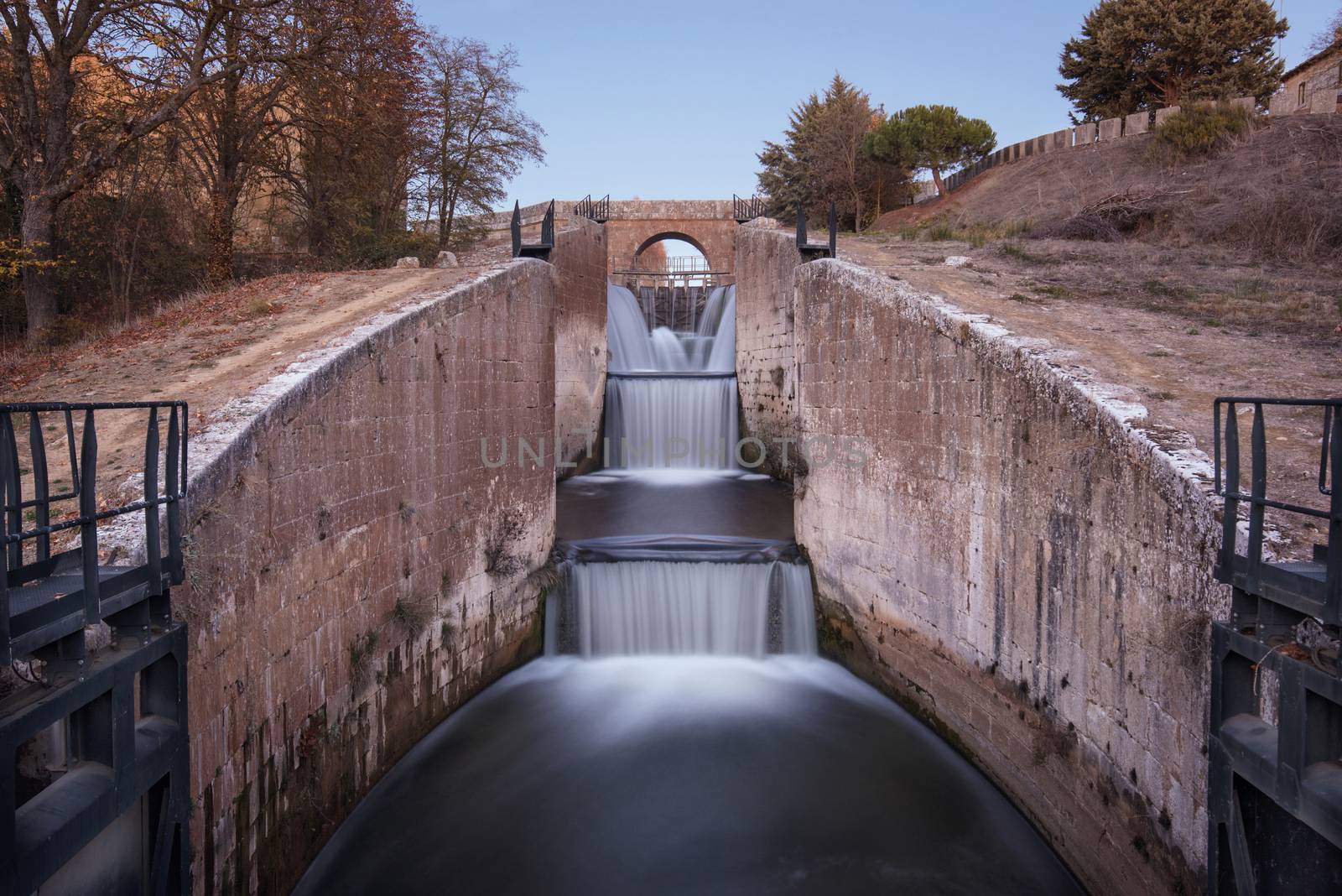 Waterfall in Touristic attraction Canal de Castilla, famous landmark in Palencia, Spain. by HERRAEZ