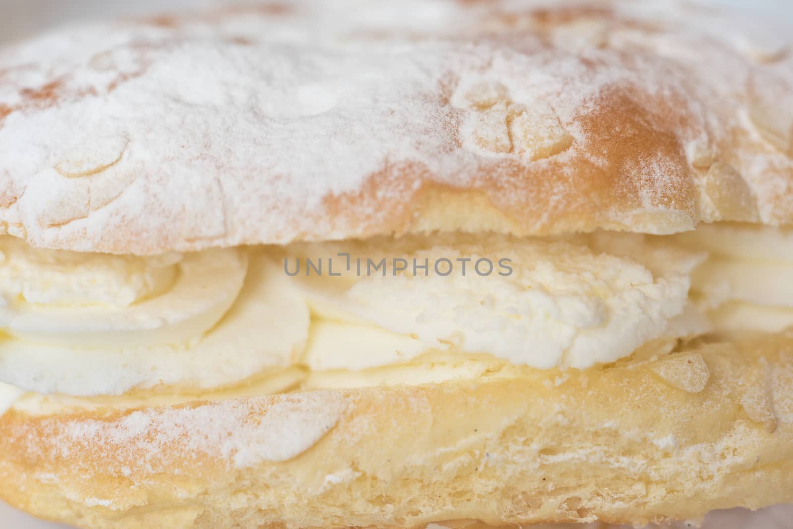 Delicious cream pastry macro picture, selective focus on the cream.