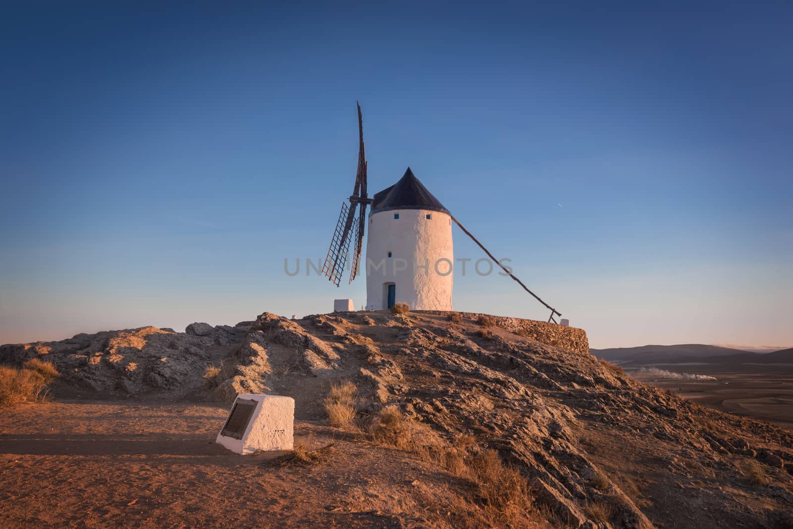 Don Quixote windmills at sunset. Famous landmark in Consuegra, Toledo Spain. by HERRAEZ