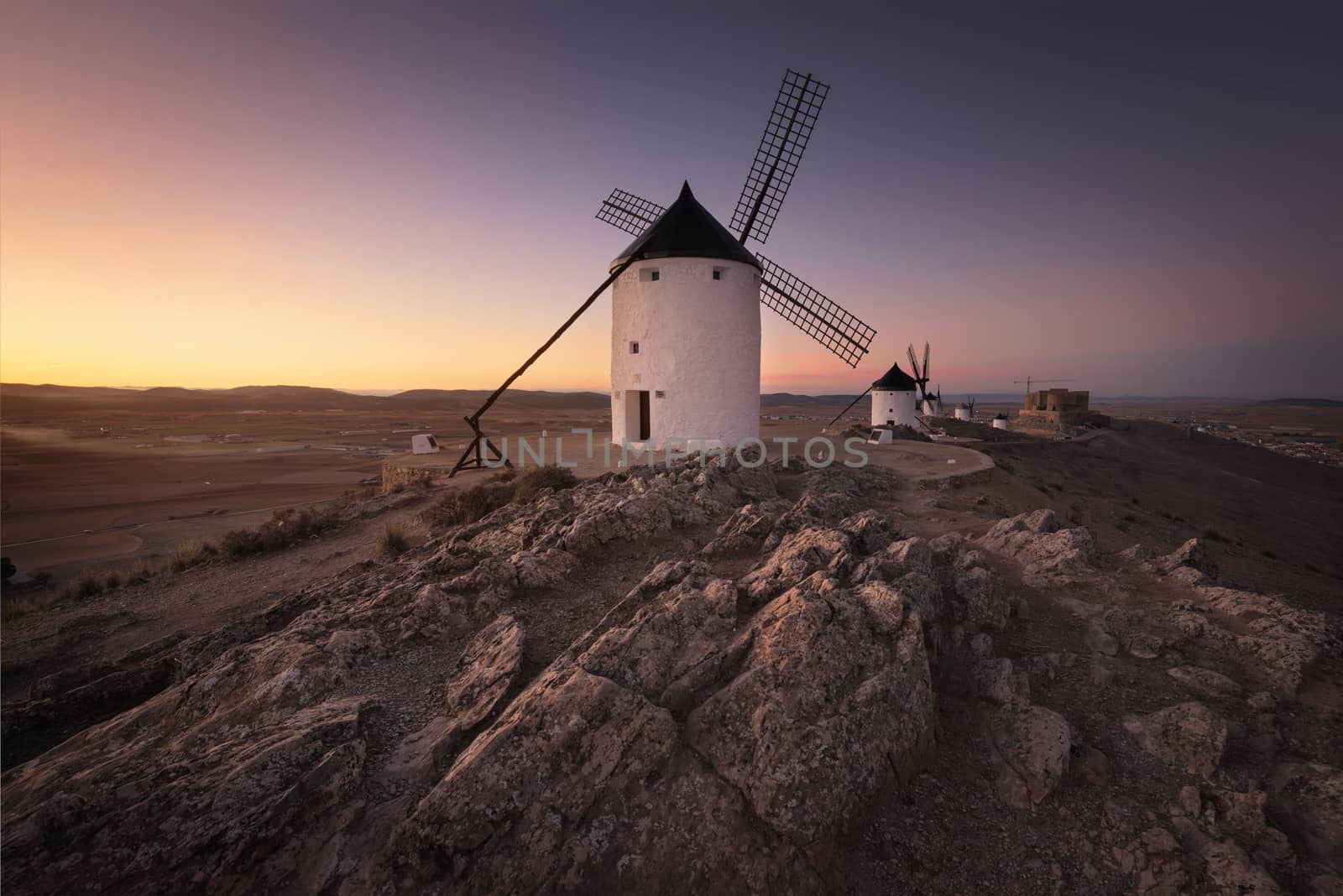 Don Quixote windmills at sunset. Famous landmark in Consuegra, Toledo Spain.