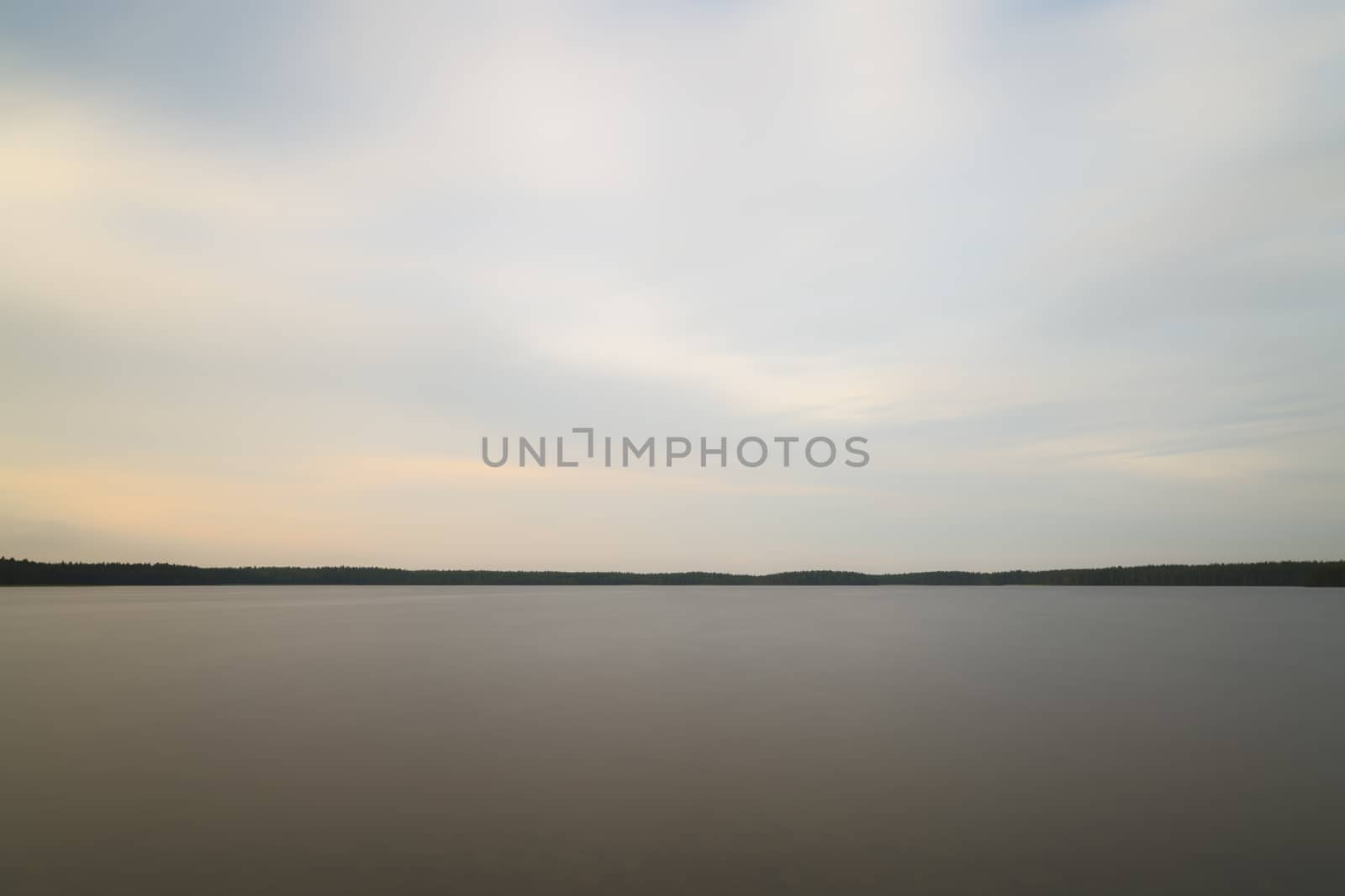Lake with clouds and Calm Water and trees.