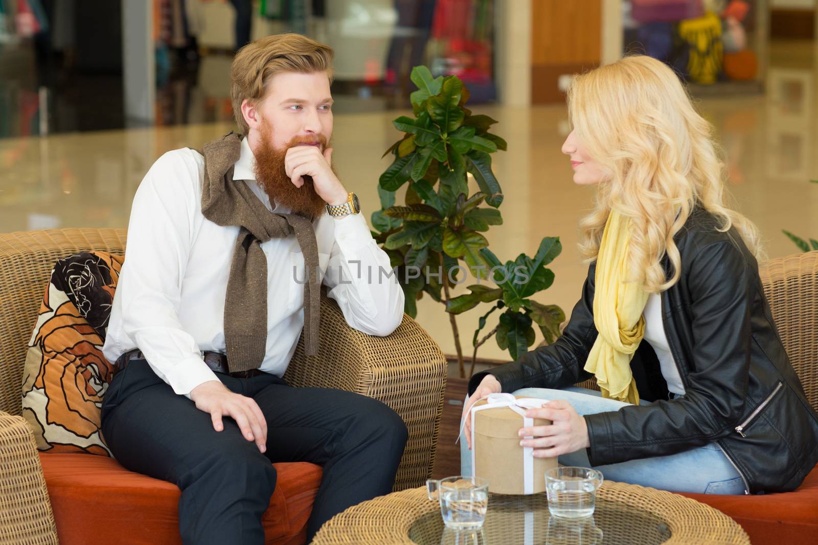 Happy beautiful young girl getting a gift from boyfriend