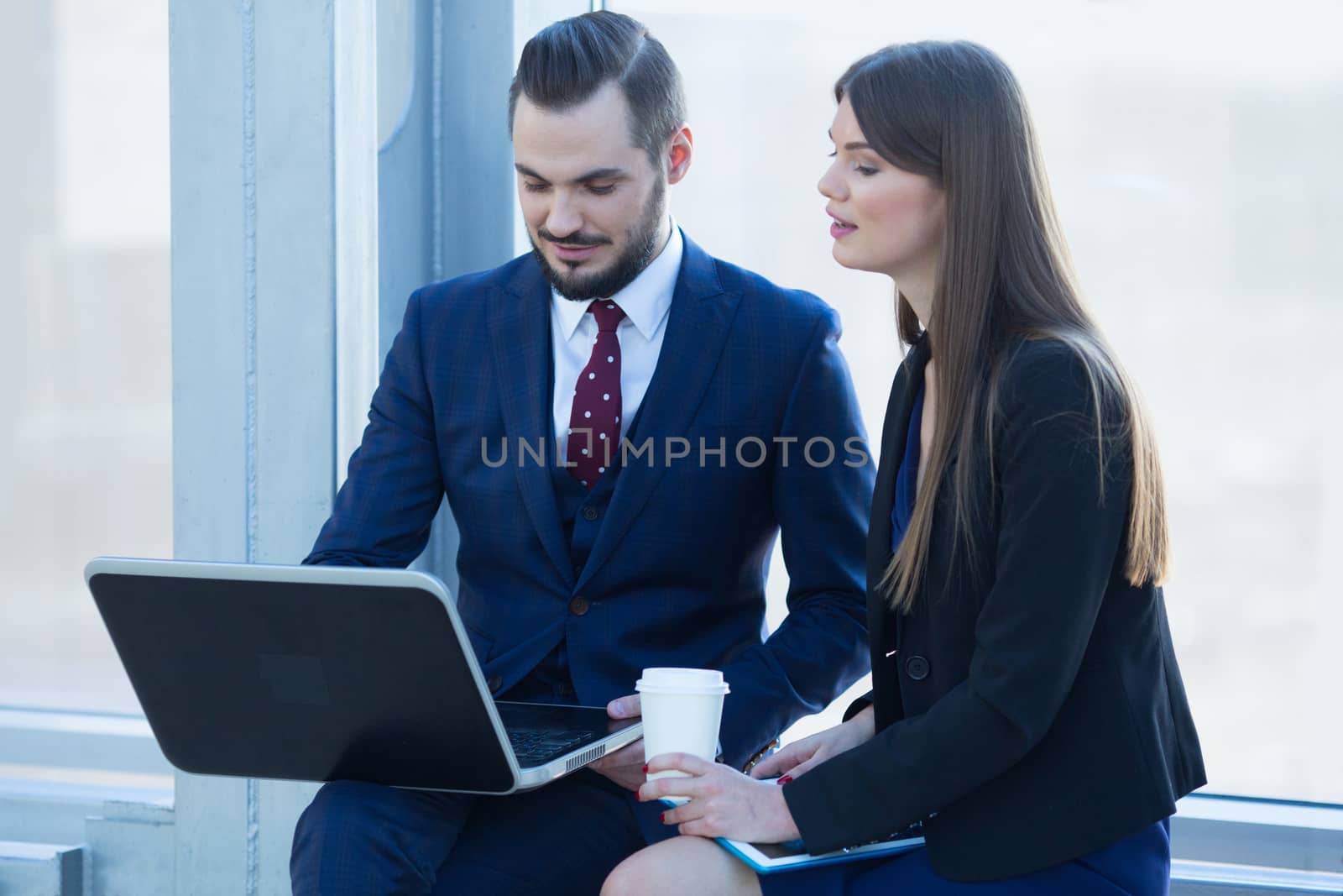 Business people with laptop by ALotOfPeople