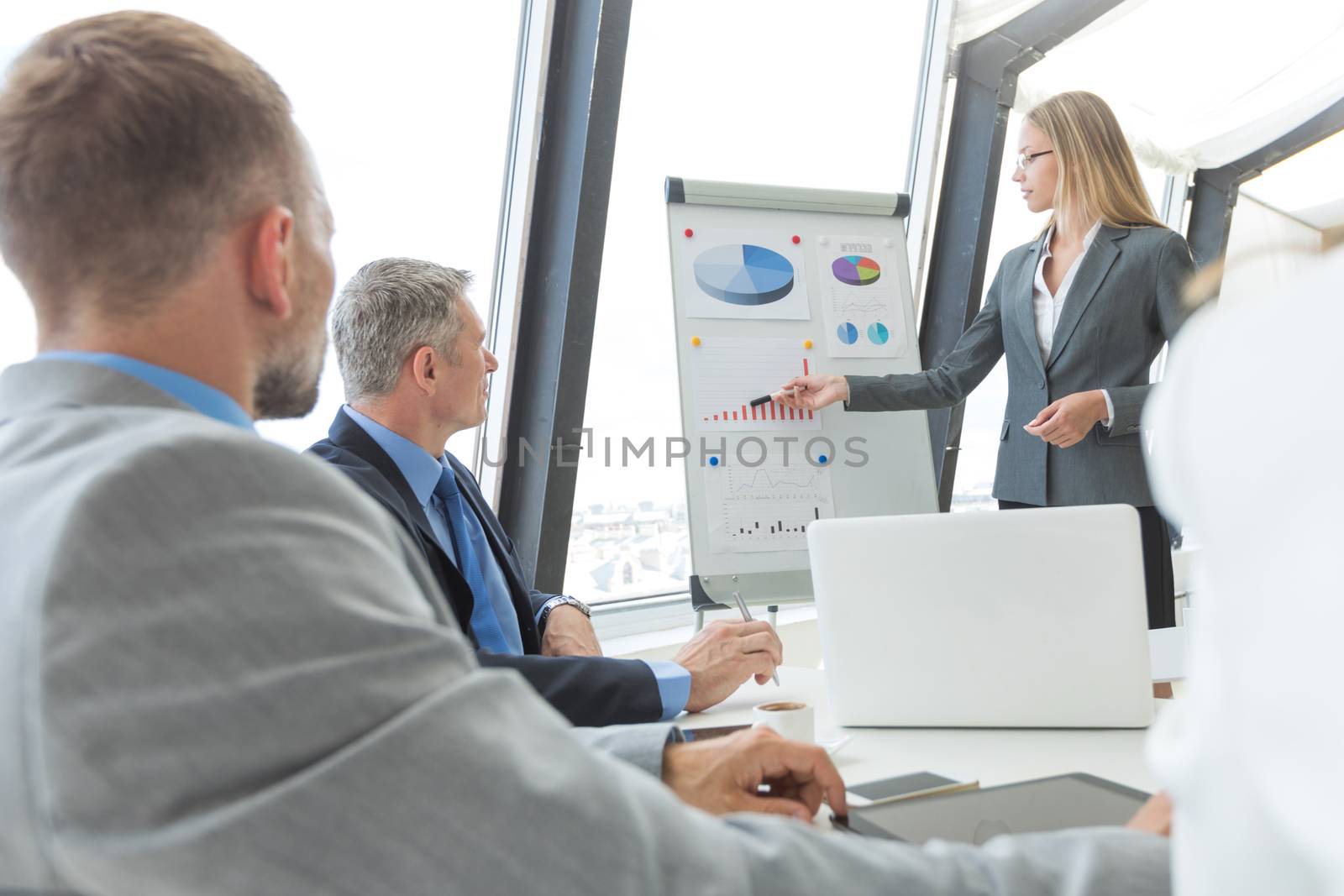 Business people team at presentation in office working with charts and diargams at flipchart