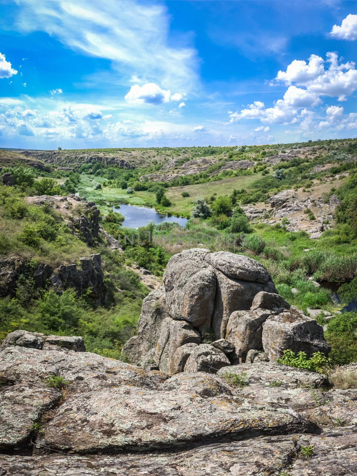 Panoramic view of deep granite Aktovo canyon with river and cloudy sky, One of the natural wonders of Ukraine.