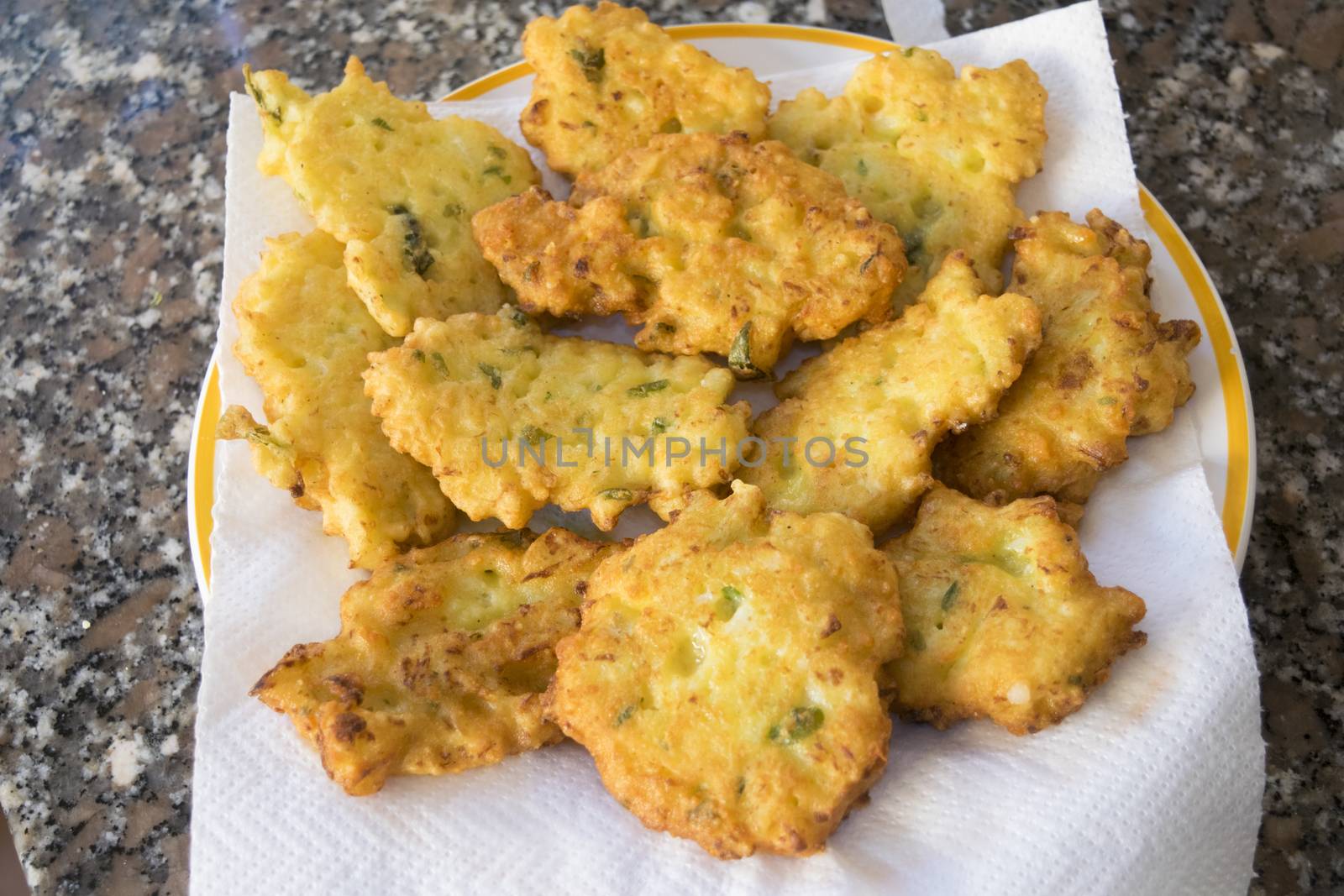 fried zucchini fritter on wooden background