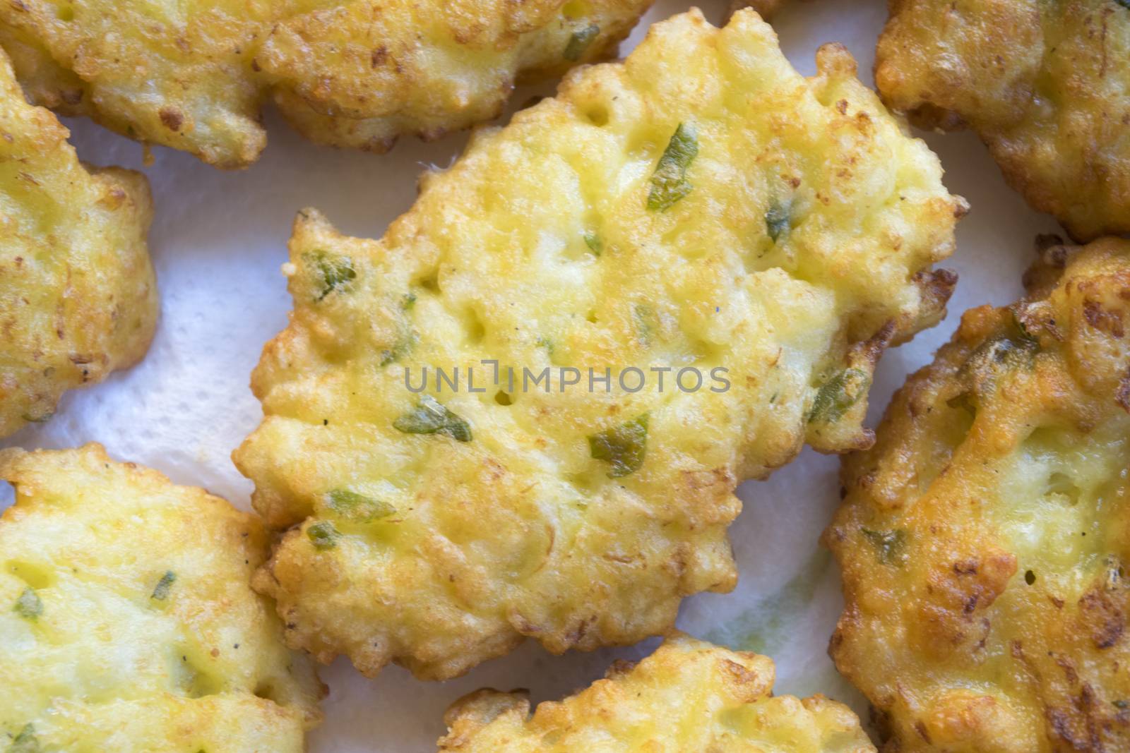 fried zucchini fritter on wooden background