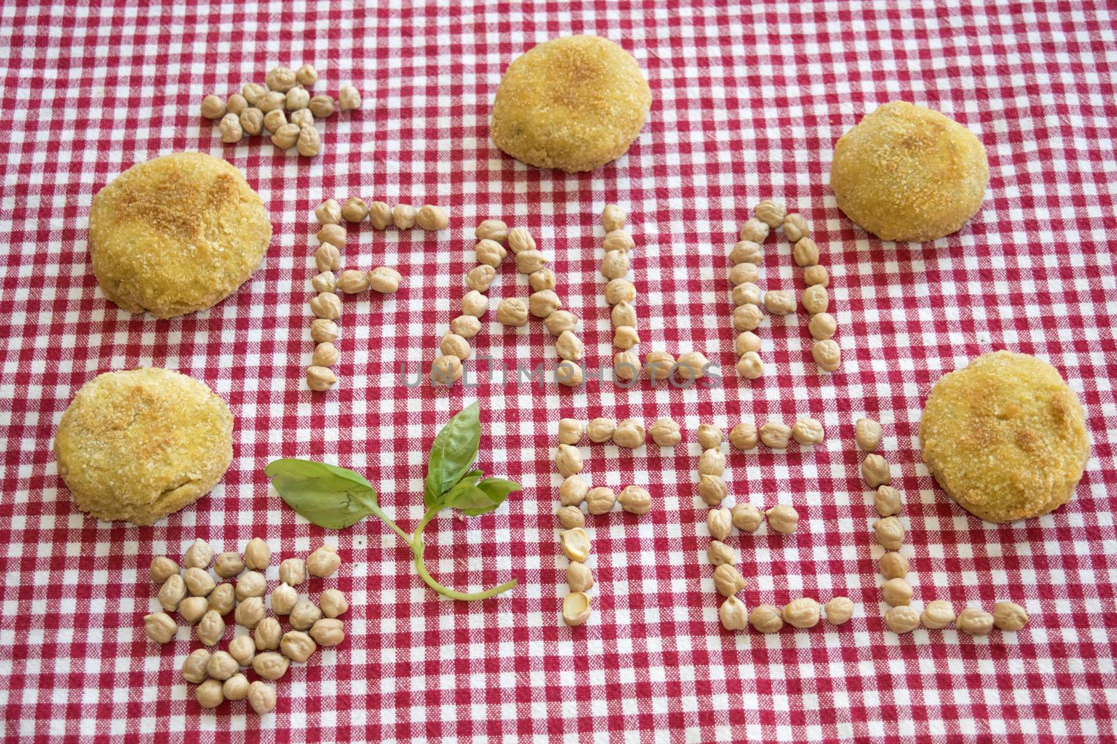 fried vegetarian falafel with near its written made with chickpeas