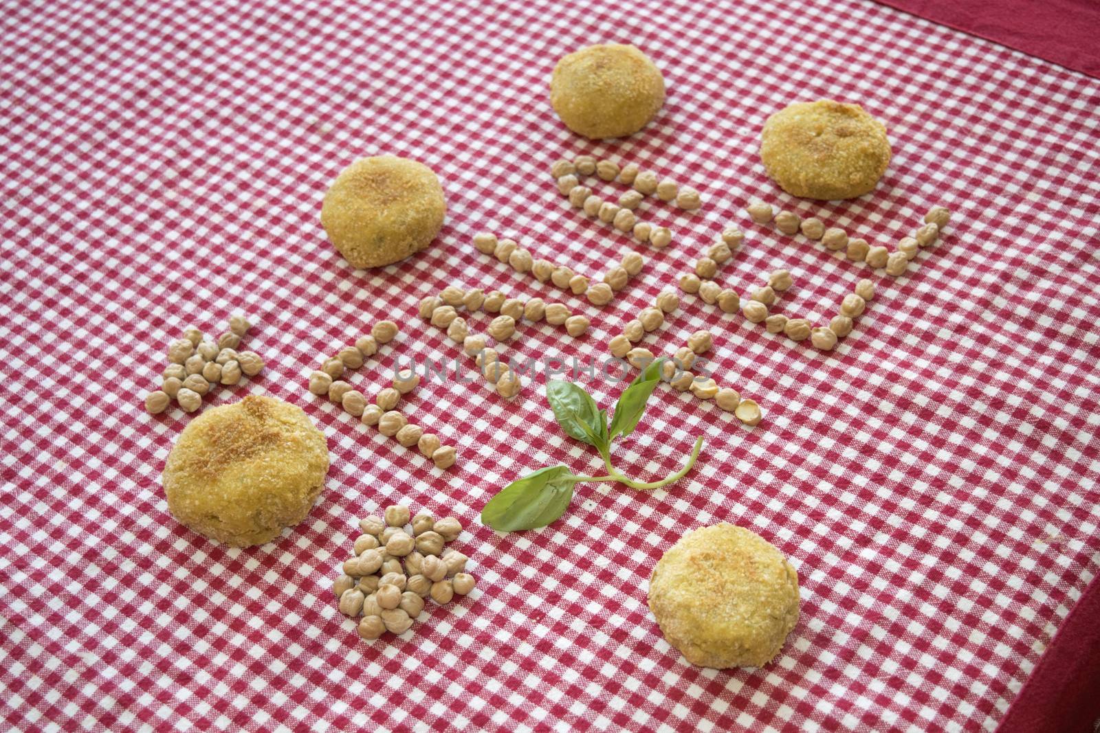 fried vegetarian falafel with near its written made with chickpeas