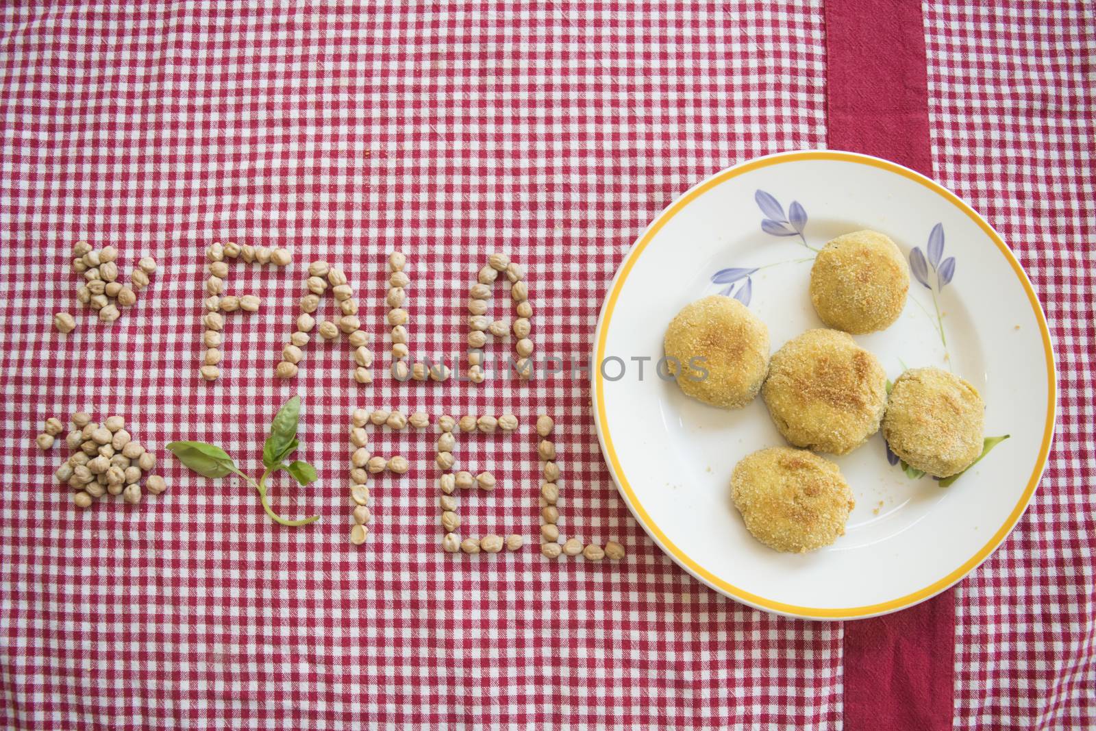 fried vegetarian falafel with near its written made with chickpeas