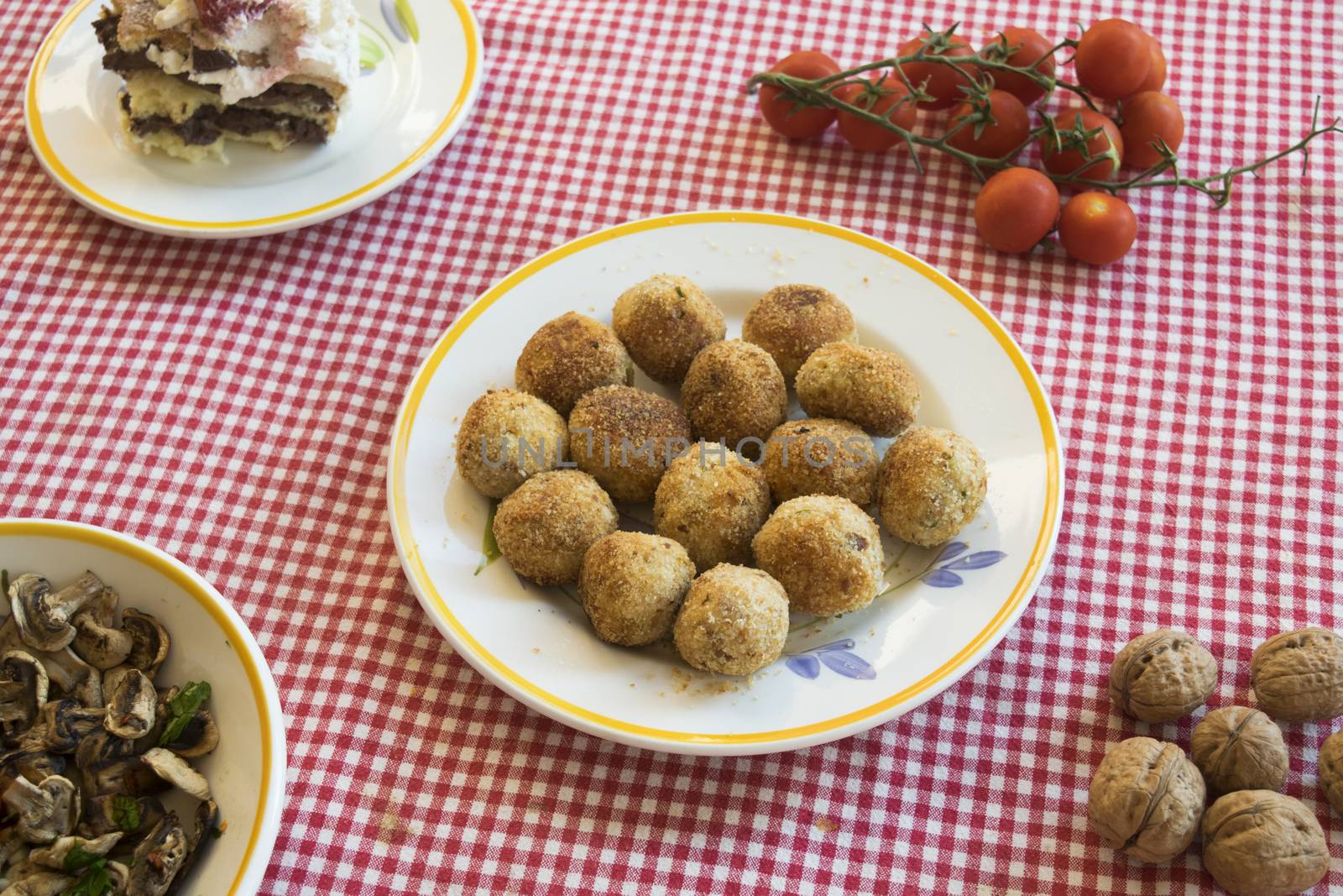 deep fried rissoles rolled in breadcrumbs on a set table