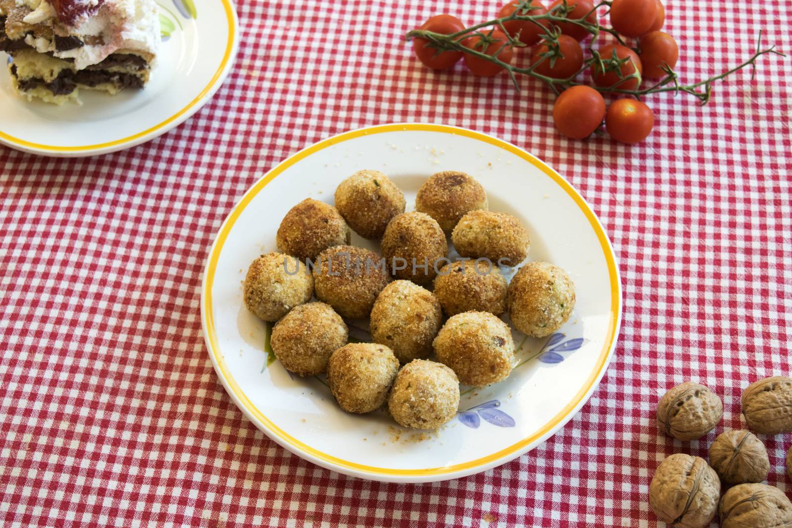 deep fried rissoles rolled in breadcrumbs on a set table