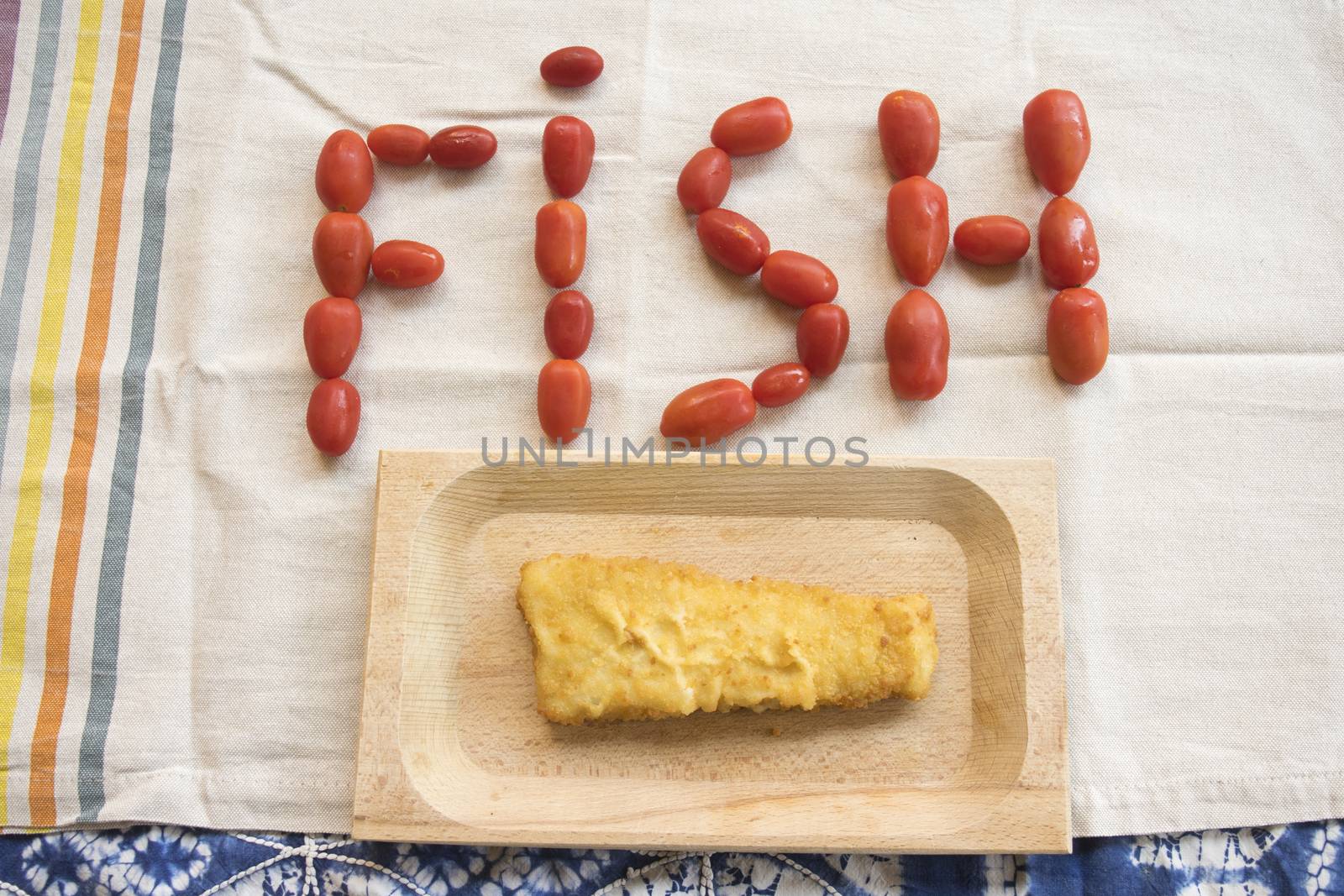 fried fish burger with near the written fish made with pachino tomatoes