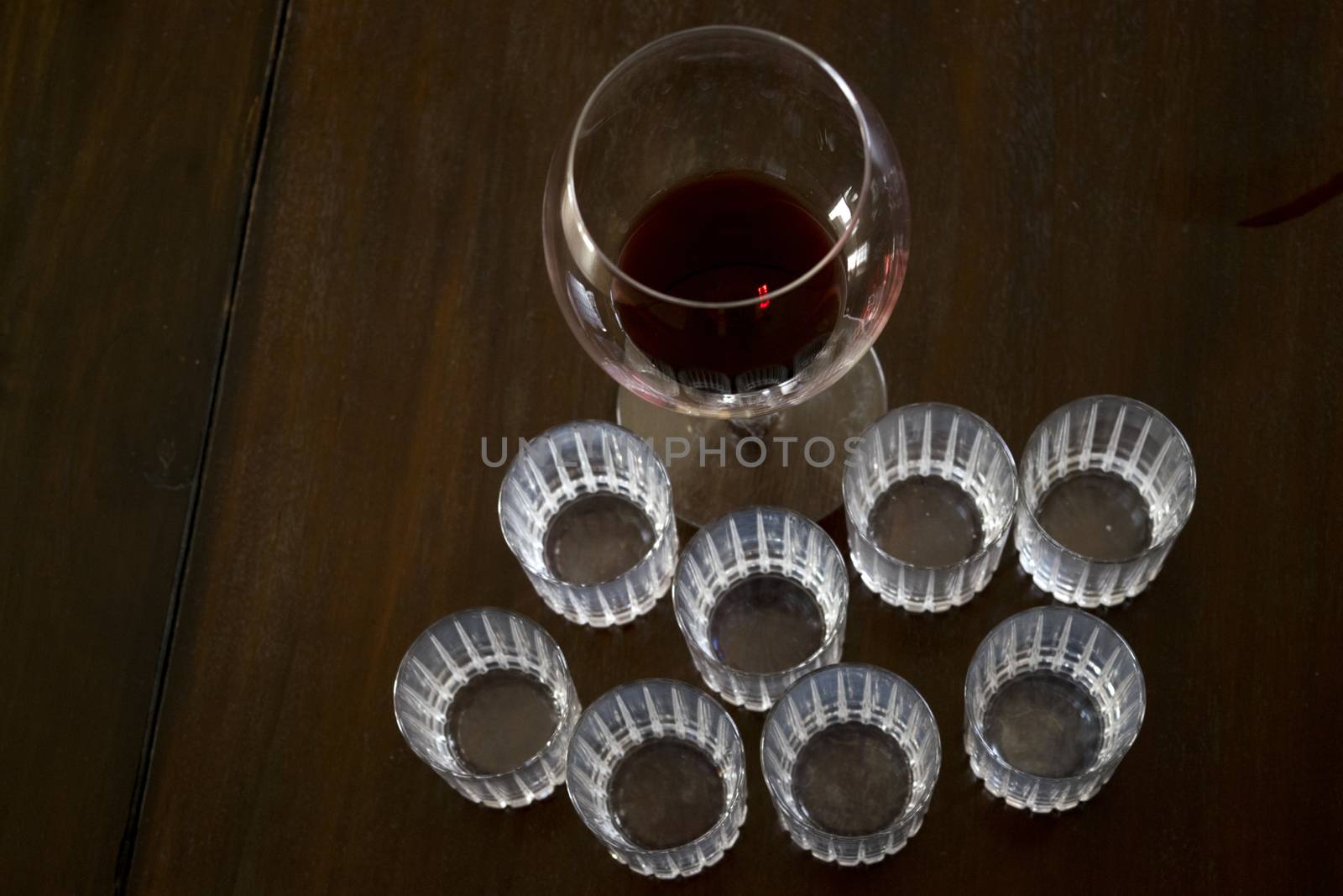 crystal ballon and liquor glasses in semi-darkness on a wooden dish