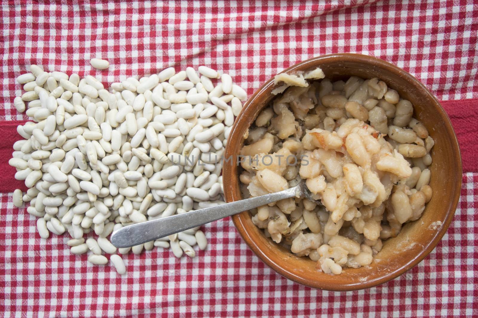 boiled navy beans in a bowl with near raw beans