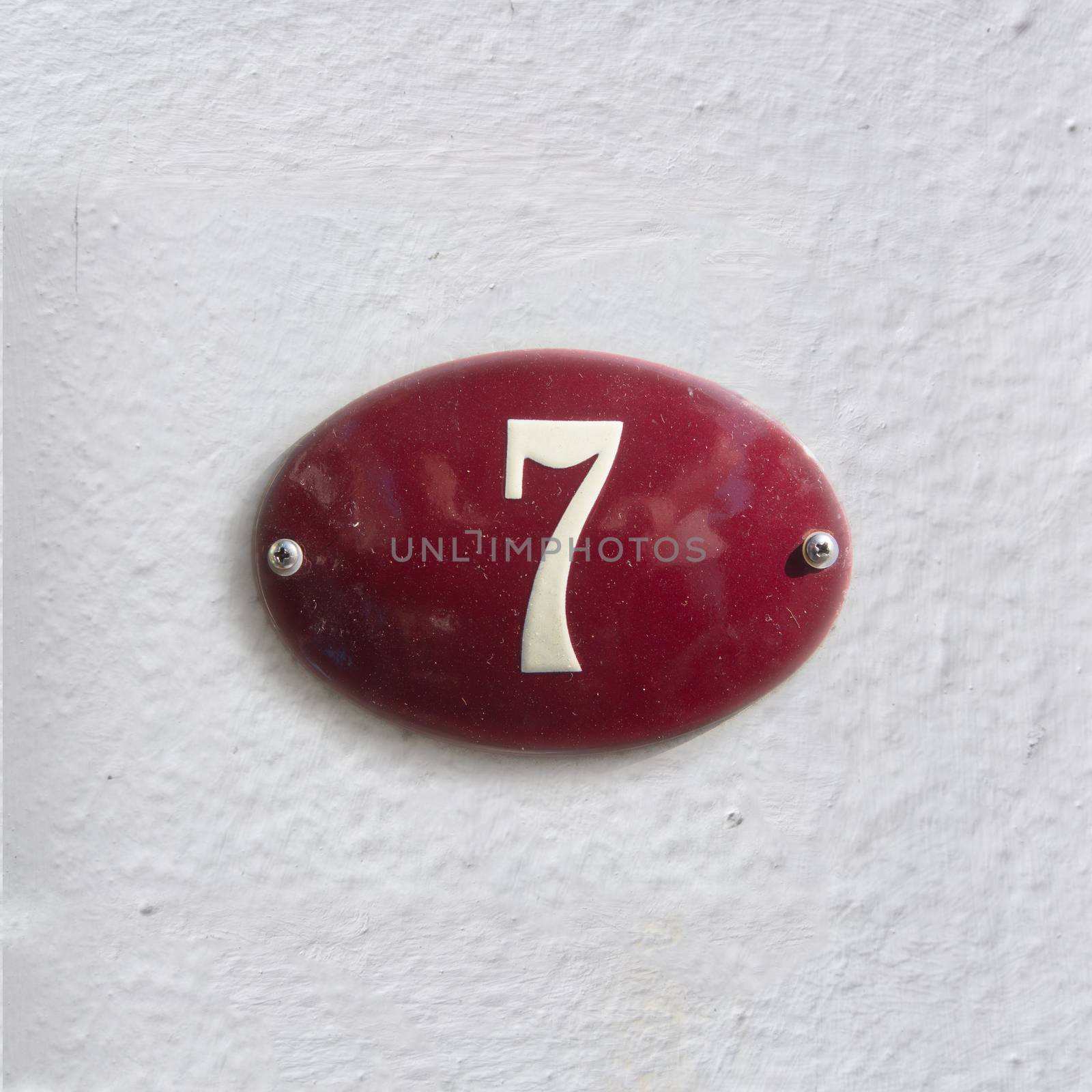 Enameled house number seven (7)
