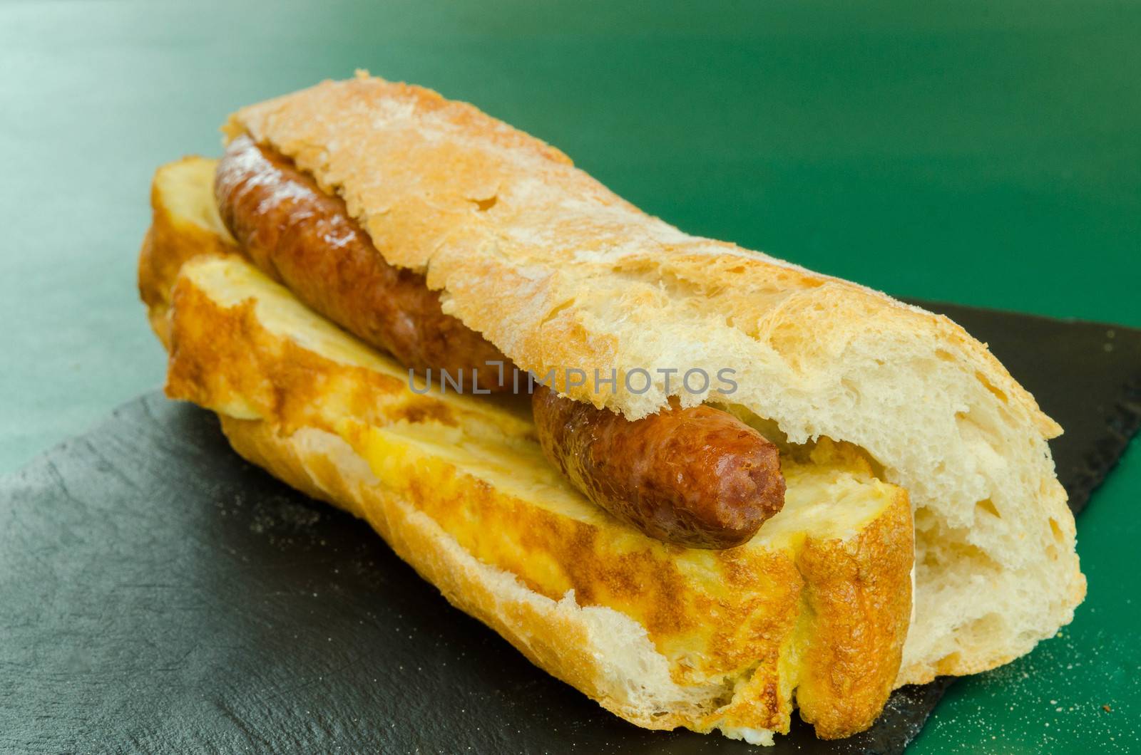 Potato omelet sandwich with pork sausage, typical Spanish lunch