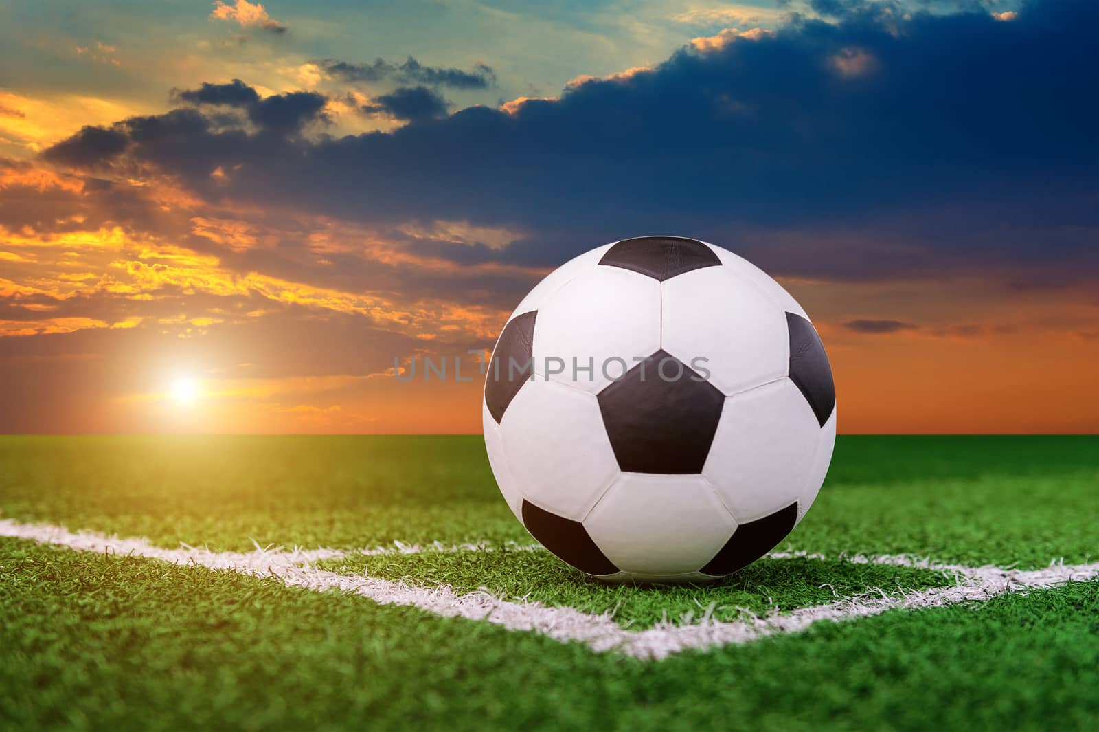 soccer ball on soccer field at sunset. by gutarphotoghaphy