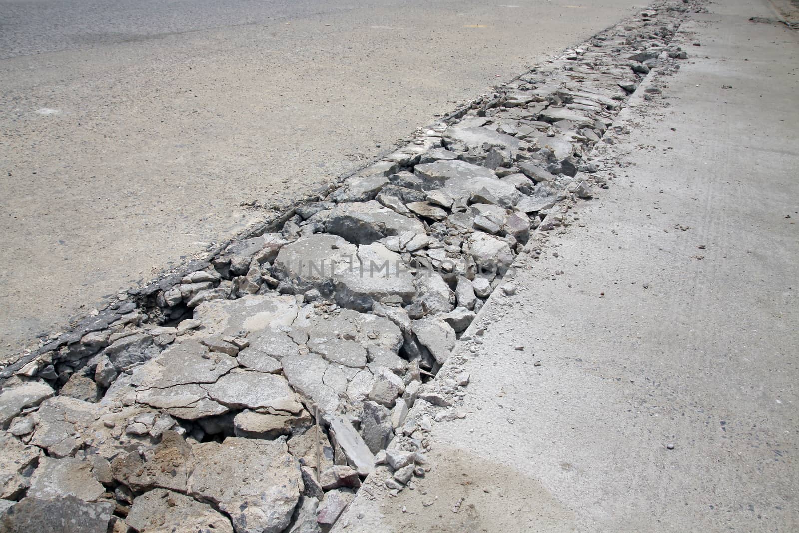Concrete road is broken for repair at construction site.