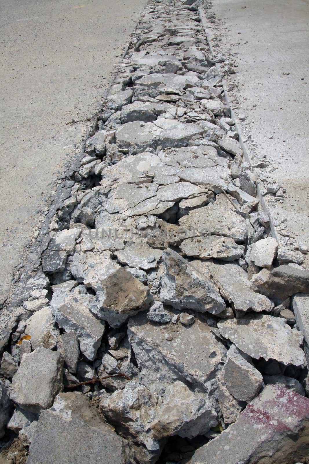 Concrete road is broken for repair at construction site.