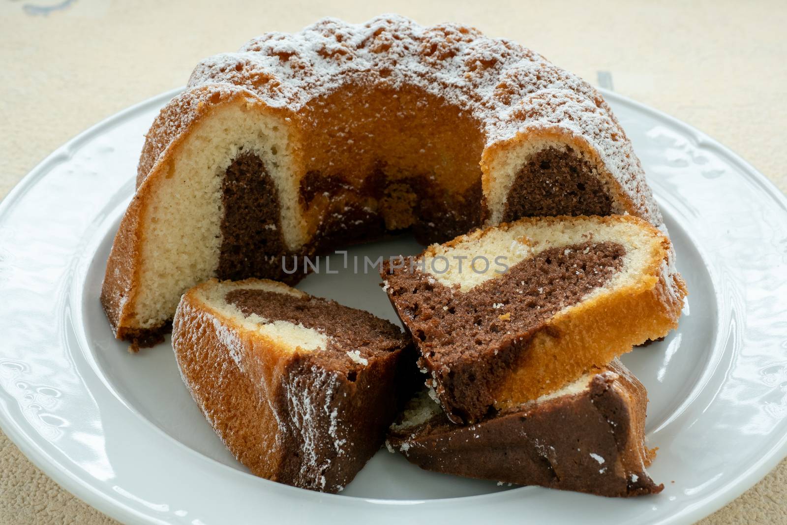 Traditional homemade marble cake. Sliced marble bundt cake on wh by xtrekx