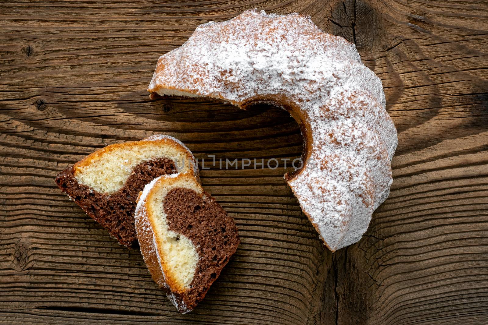 Traditional homemade marble cake. Sliced marble bundt cake on wooden table