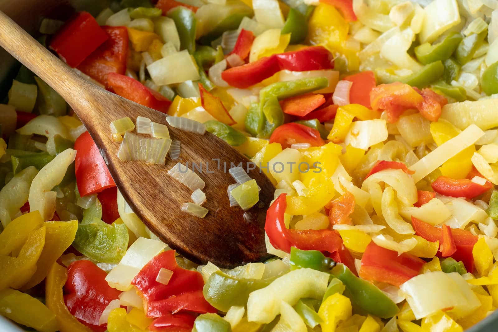 Fried pepper on a frying pan. Fried colorful vegetables on a frying pan.