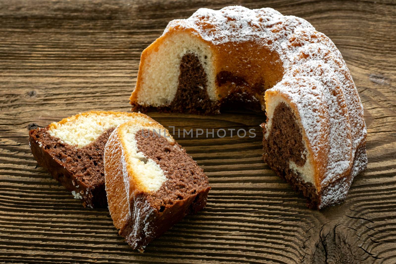 Traditional homemade marble cake. Sliced marble bundt cake on wooden table