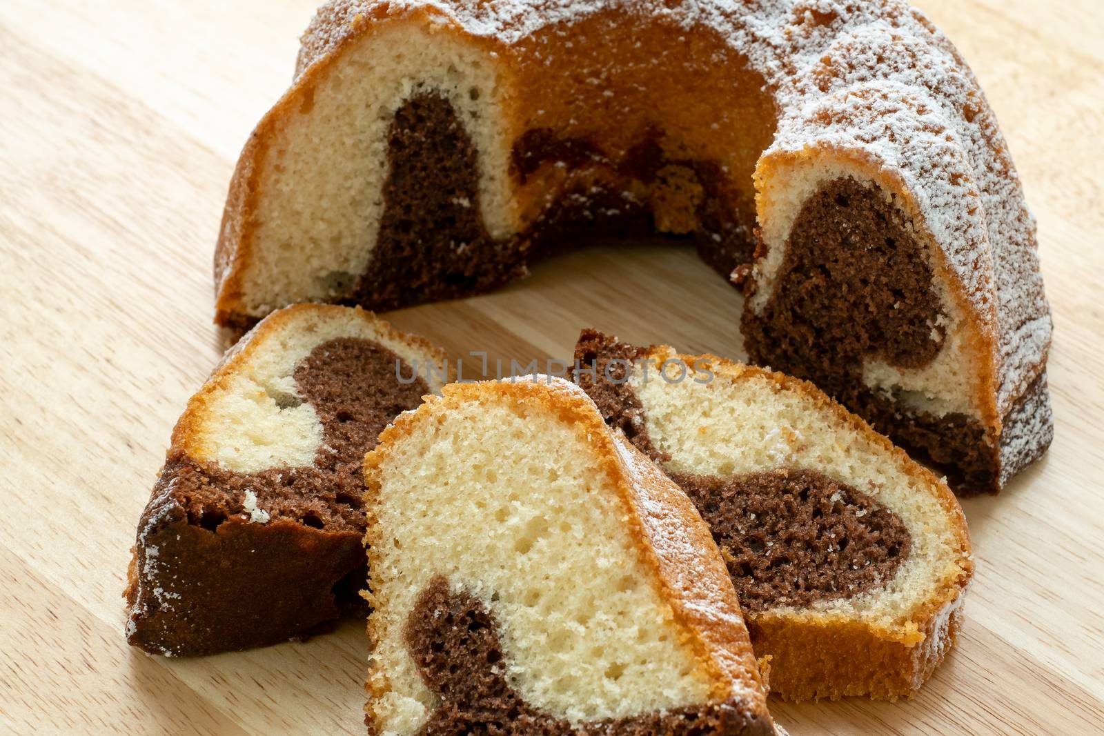 Traditional homemade marble cake. Sliced marble bundt cake on wooden table