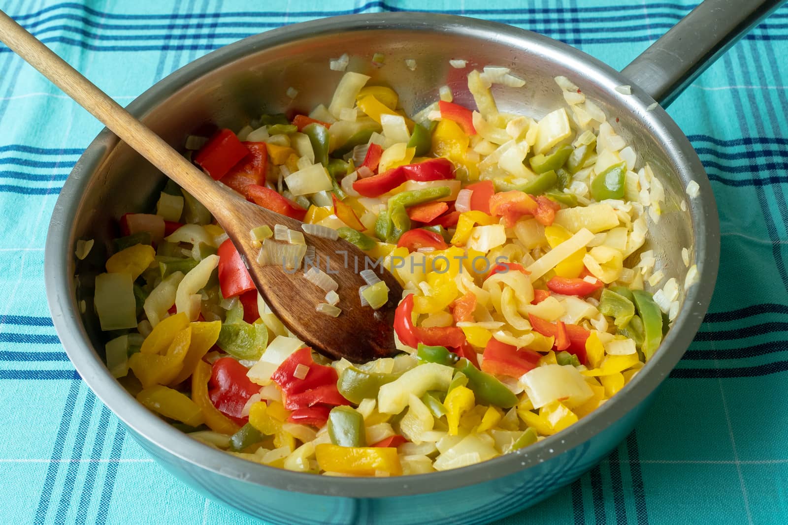 Fried pepper on a frying pan. Fried colorful vegetables on a frying pan.