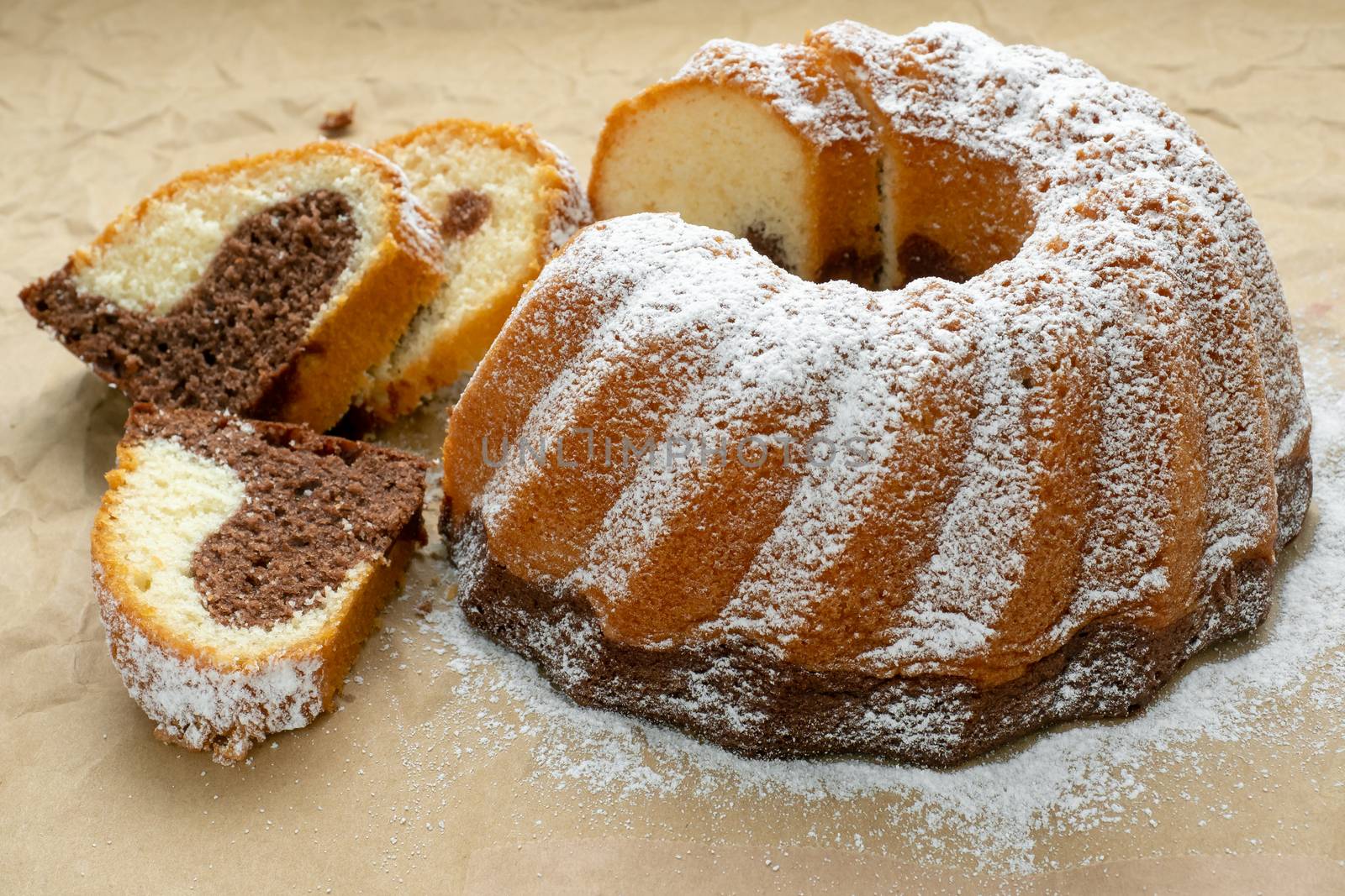 Traditional homemade marble cake. Sliced marble bundt cake on paper.