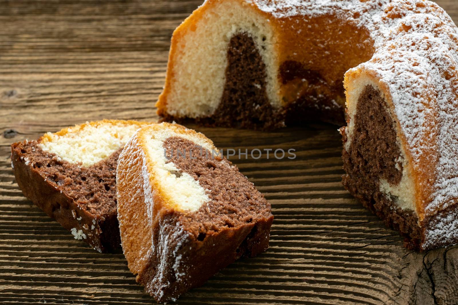 Traditional homemade marble cake. Sliced marble bundt cake on wooden table