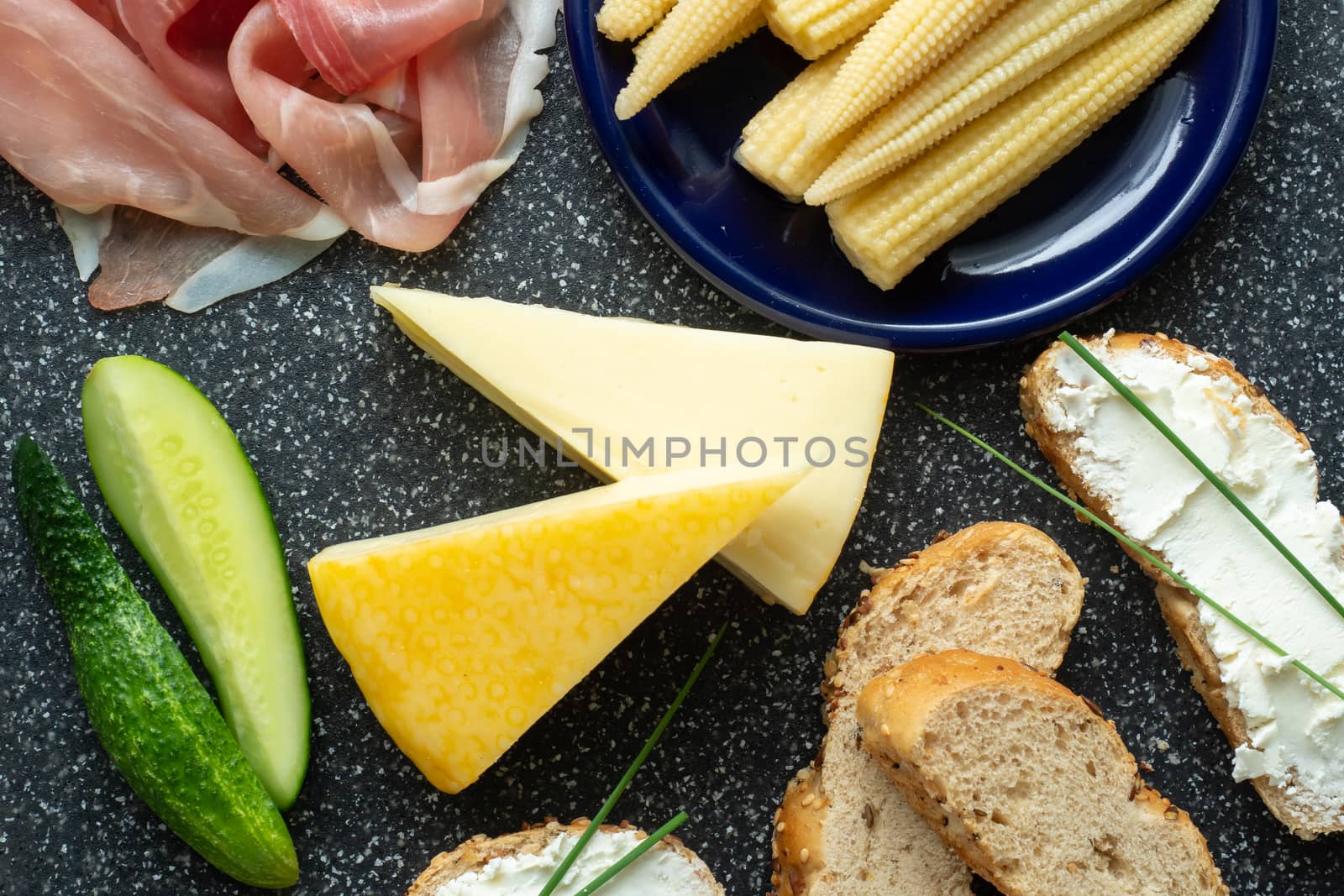 Cold appetizer. Cold cuts. Spicy food on black background, top view.