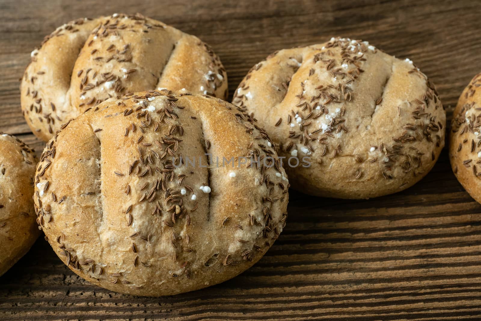 Bread rolls sprinkled with salt and caraway. Bakery assortment of bread.