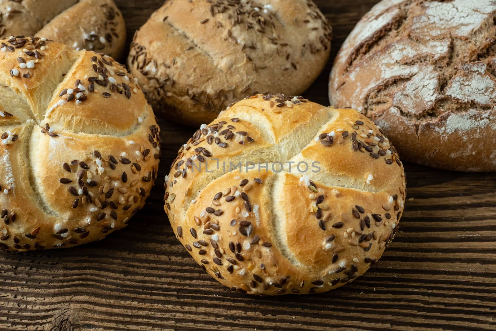Different bread on a rustic wooden background. Bakery assortment of bread.