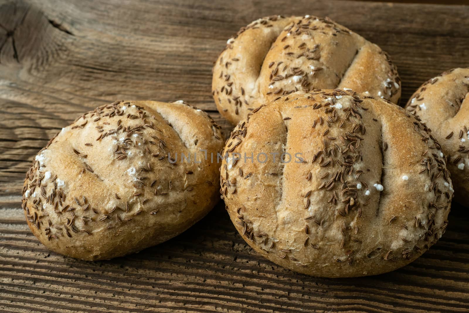 Bread rolls sprinkled with salt and caraway. Bakery assortment o by xtrekx