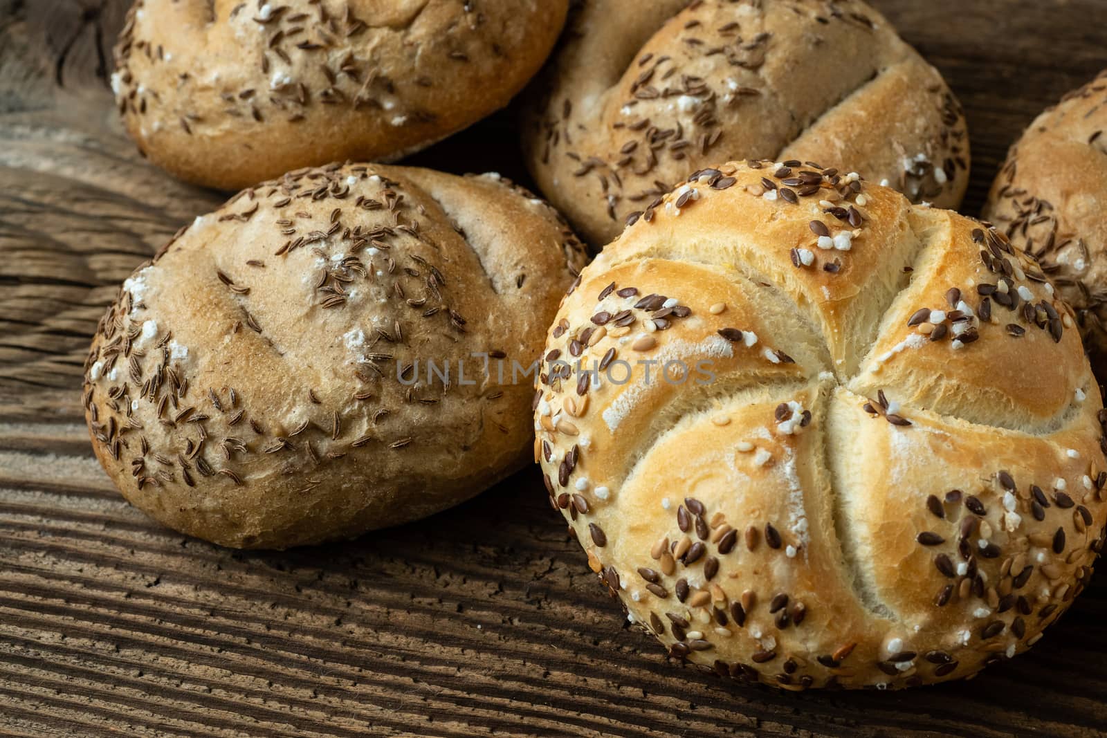 Different bread on a rustic wooden background. Bakery assortment by xtrekx