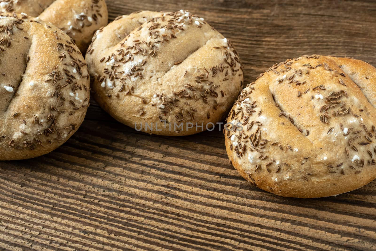 Bread rolls sprinkled with salt and caraway. Bakery assortment of bread.