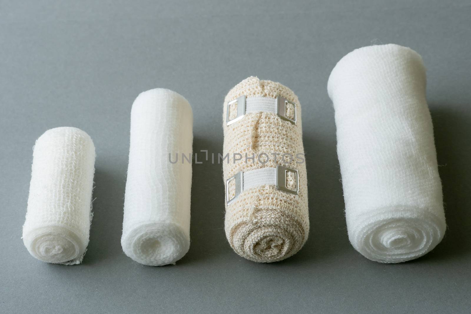 Different sizes of medical bandages. Medical bandages on grey ba by xtrekx