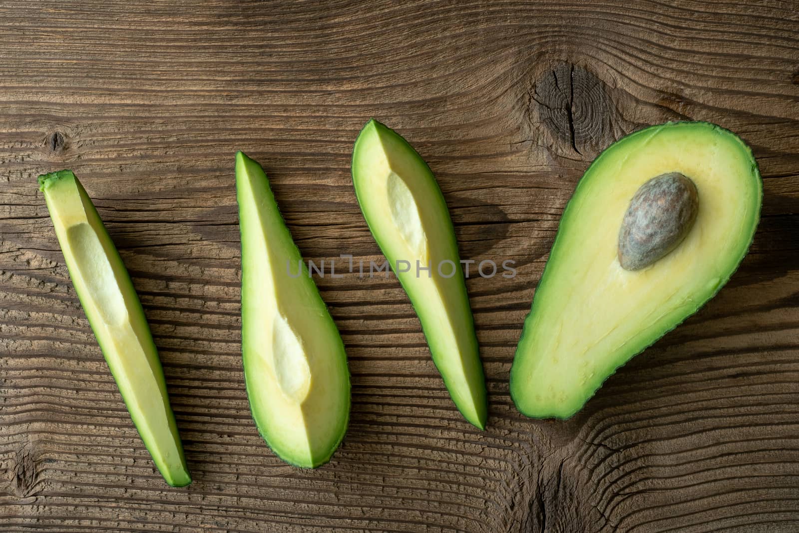 Fresh organic avocado on old wooden table. Avocado on a wooden background.