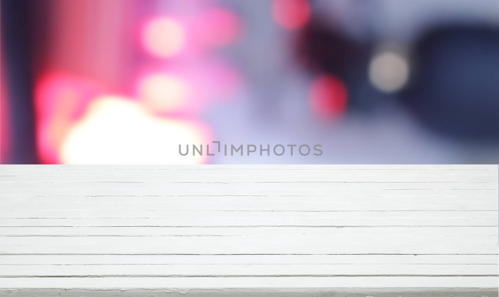 White wooden table for product presentation with colorful bokeh by xamtiw