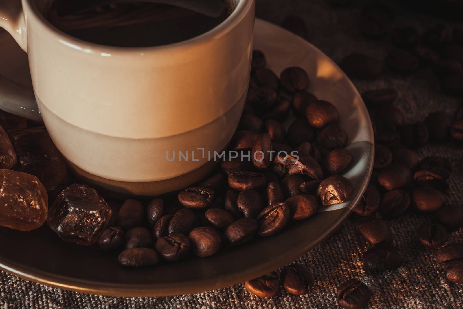 Cup on saucer with scattering of coffee beans and sugar by Seva_blsv